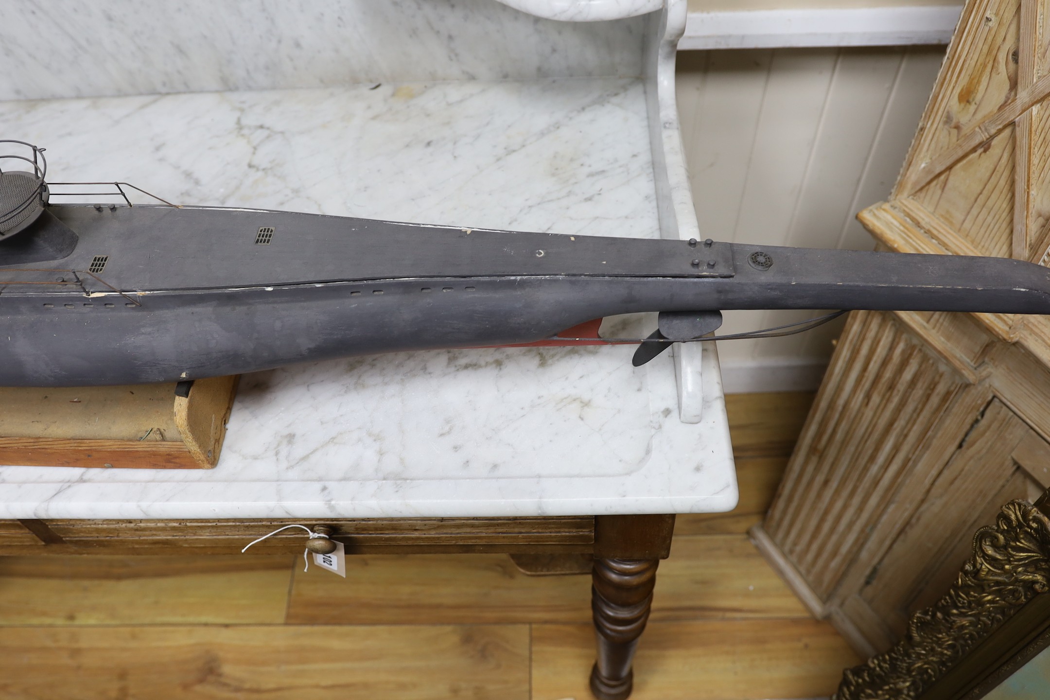 A painted wood model of a German U boat, 170 cms long